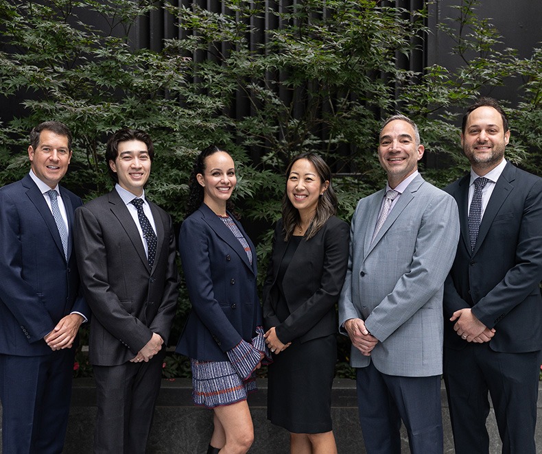Five smiling endodontists at J C Endodontics Root Canal Specialists in New York City