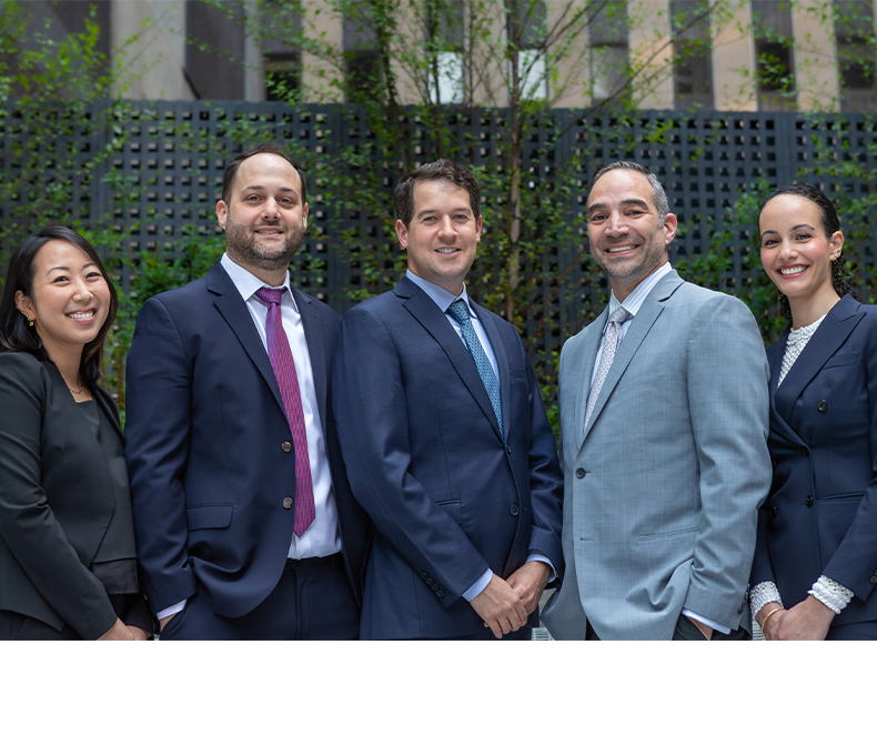 Five smiling endodontists at J C Endodontics Root Canal Specialists in New York City