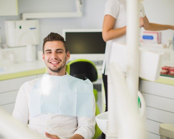 Smiling young man sitting in dental chair