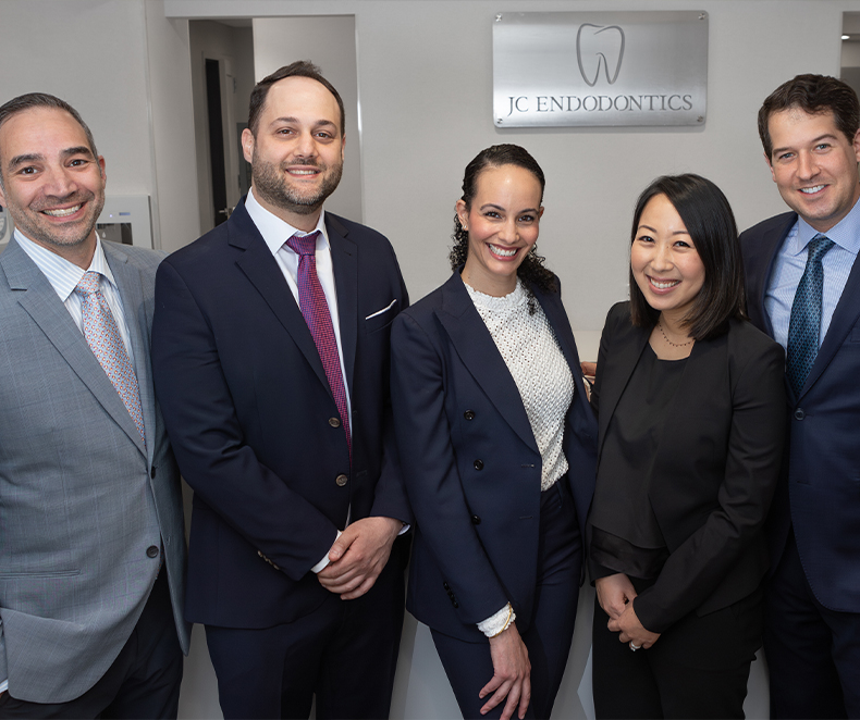 Five smiling endodontists at J C Endodontics Root Canal Specialists in New York City