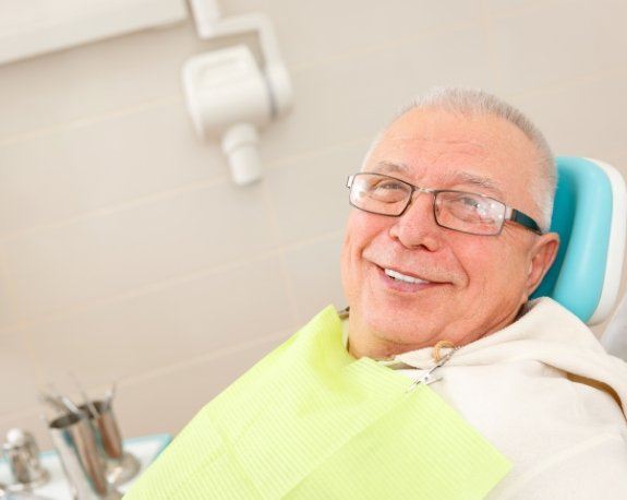 Senior man smiling in dental chair