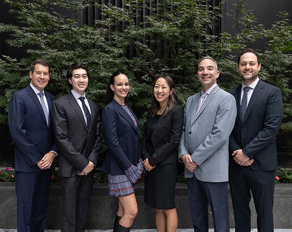 Smiling New York City endodontists at J C Endodontics Root Canal Specialists