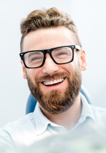 young man smiling in dental chair 