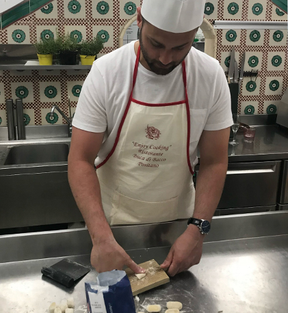 Doctor Forghani wearing apron while baking