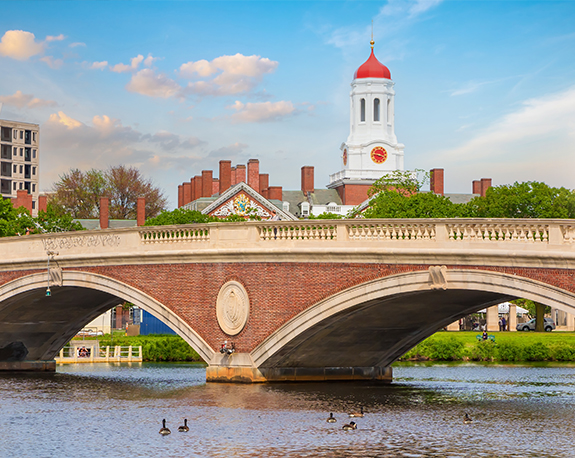 Red brick bridge over pond on academic campus