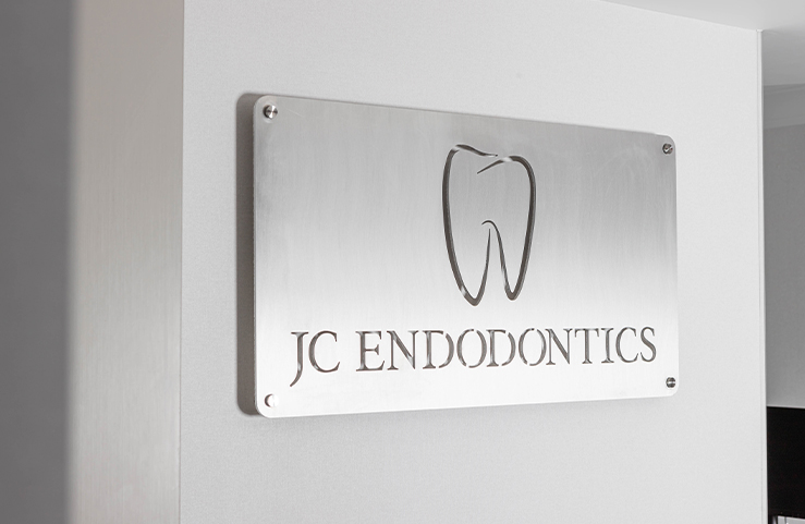 J C Endodontics Root Canal Specialists sign on wall of New York City endodontic office