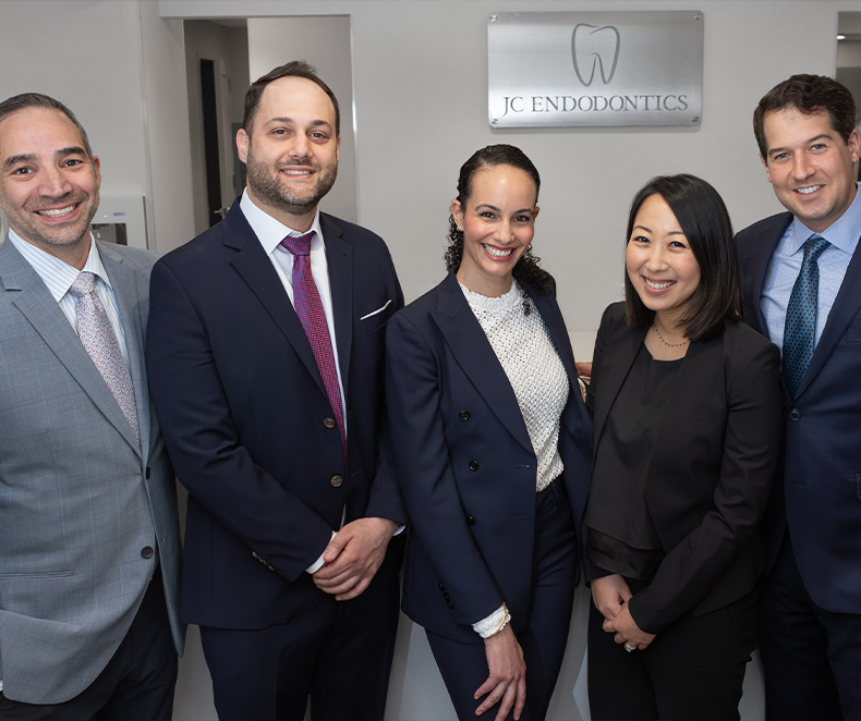 Five smiling experts in root canal treatment in New York City