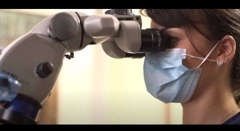 Man and woman in white lab coats looking at the camera