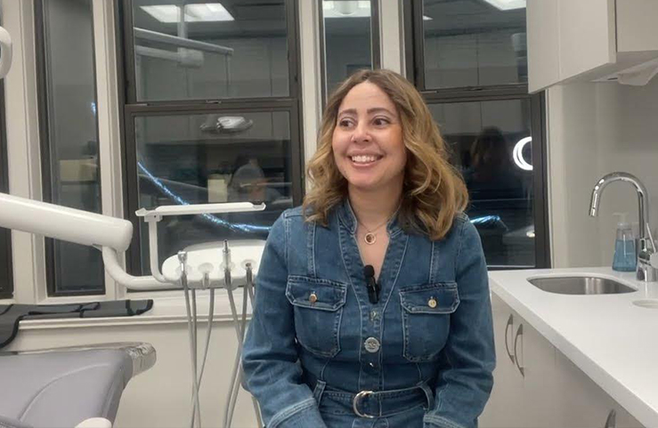 Woman in denim jacket sitting in treatment chair in New York City endodontic office