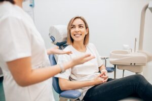 Dentist and patient engaged in friendly conversation 