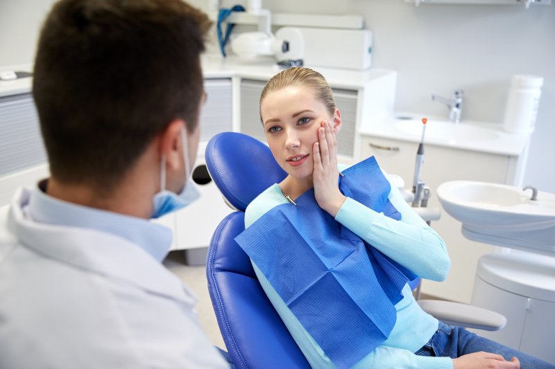 A pained woman about to receive a root canal 
